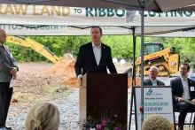 Congressman Brian Jack standing at a podium and addressing a crowd at the groundbreaking ceremony for the new Griffin-Spalding Regional Airport